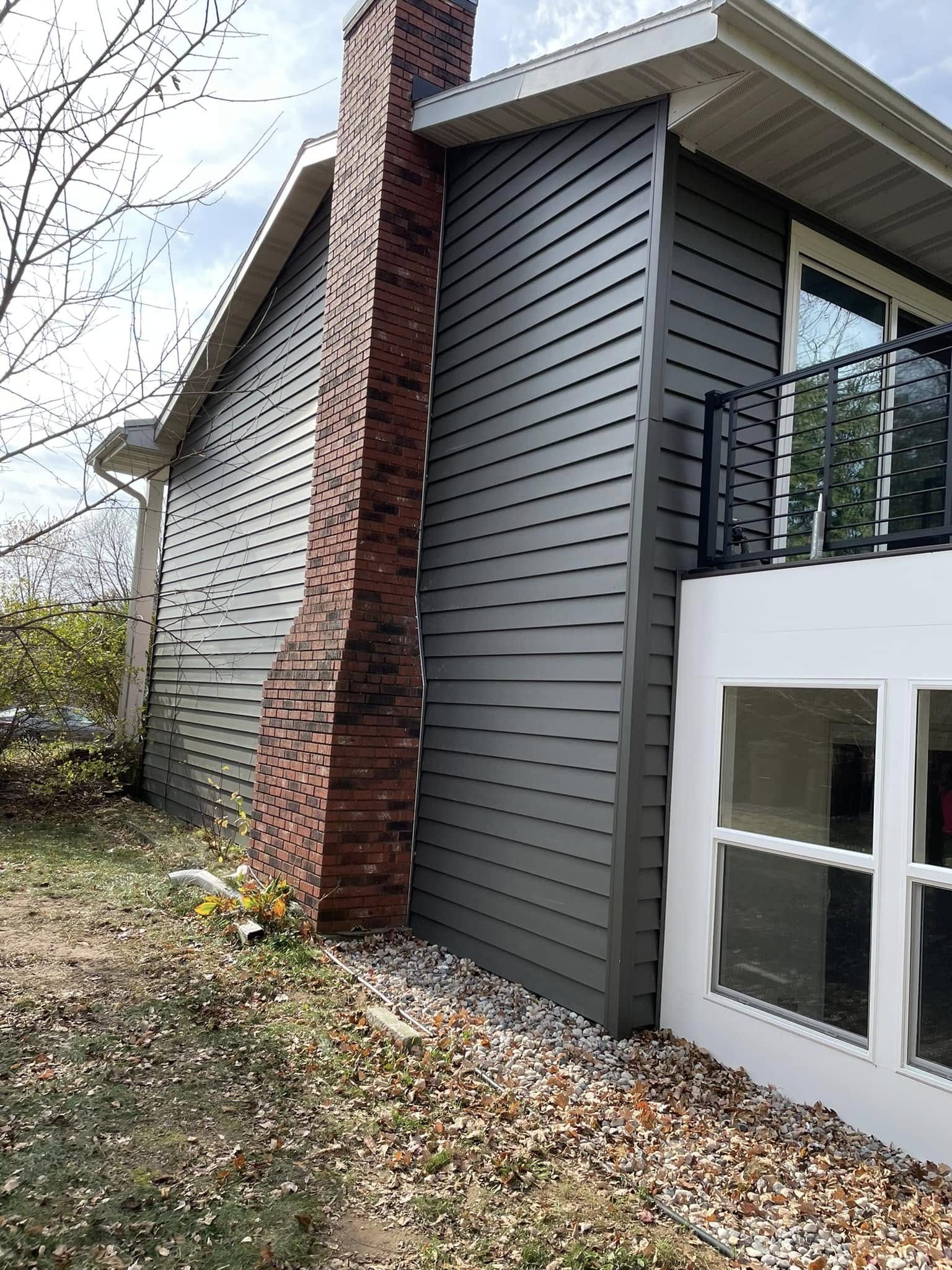 home side view with new chimney and siding